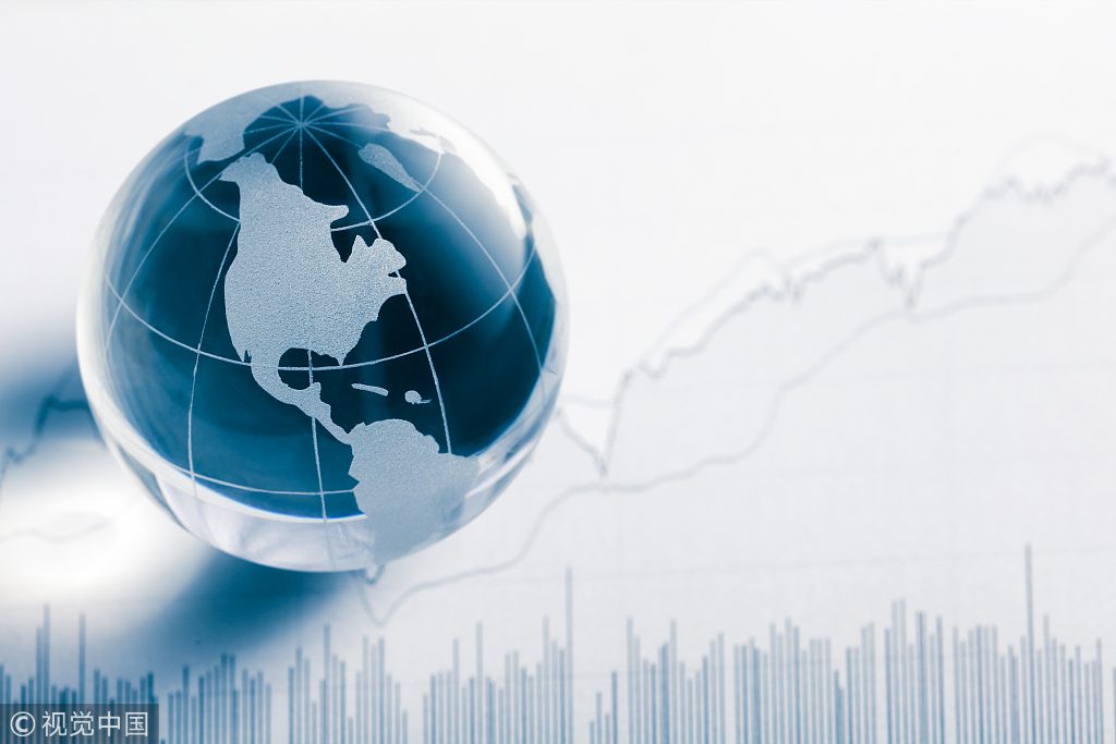 Business concept. Glass globe (america map) and stock market chart on newspaper background