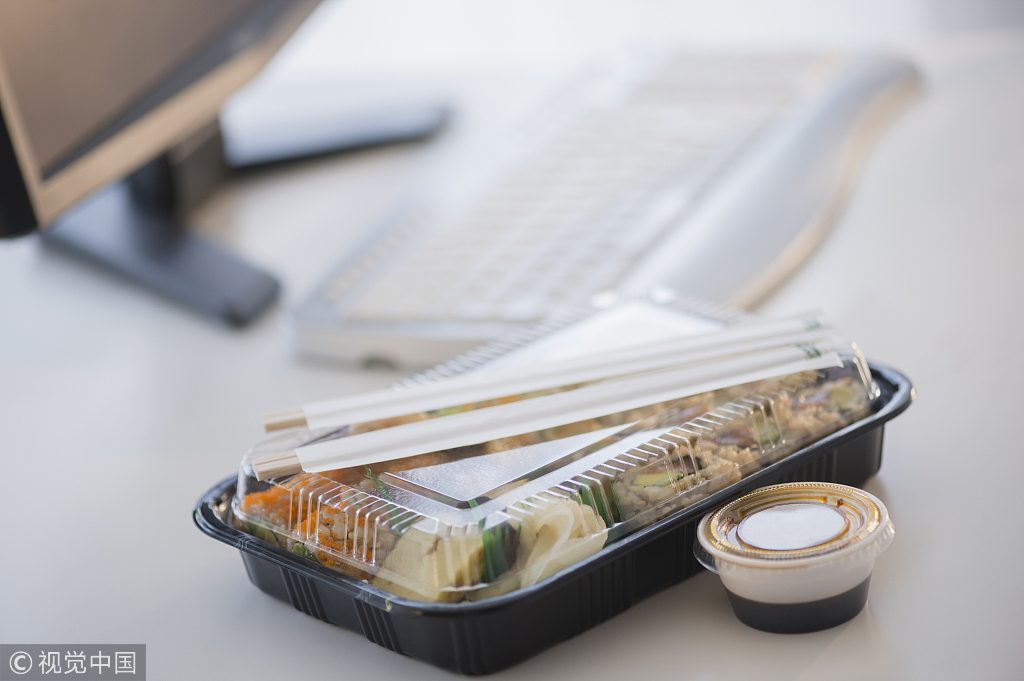 Close up of take-out lunch near computer