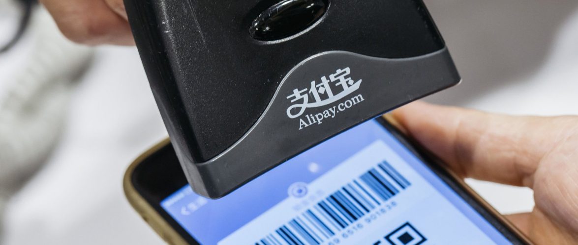 An employee scans a quick response (QR) code displayed on the Ant Financial Services Group's Alipay app, an affiliate of Alibaba Group Holding Ltd., inside a Sa Sa International Holdings Ltd. store in an arranged photograph in Hong Kong, China, on Tuesday, Nov. 1, 2016. The urgency to prepare regulatory environments for fintech is growing as banks begin offering digital services such as biometric authentication and as mobile-payment systems such as Apple Pay and AliPay are introduced around the region. Photographer: Anthony Kwan/Bloomberg