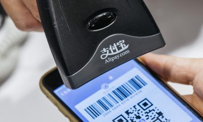An employee scans a quick response (QR) code displayed on the Ant Financial Services Group's Alipay app, an affiliate of Alibaba Group Holding Ltd., inside a Sa Sa International Holdings Ltd. store in an arranged photograph in Hong Kong, China, on Tuesday, Nov. 1, 2016. The urgency to prepare regulatory environments for fintech is growing as banks begin offering digital services such as biometric authentication and as mobile-payment systems such as Apple Pay and AliPay are introduced around the region. Photographer: Anthony Kwan/Bloomberg