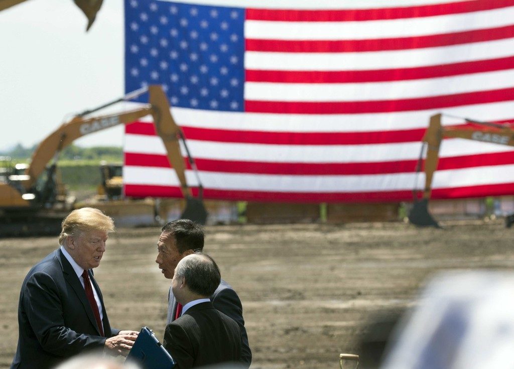 June 28, 2018; Mount Pleasant, WI, USA; President Trump (left) and Foxconn chairman Terry Gou (back) and Softbank CEO Masayoshi Son are shown during the ceremonial groundbreaking for Foxconn's factory in Mount Pleasant. The Taiwanese-Based firm has said “categorically” that it remains committed to investing the full $10 billion in what it has named the Wisconn Valley Science and Technology Park, and to creating 13,000 jobs. The factory will create display panels out of immense sheets of wafer-thin glass. Mandatory Credit: Mark Hoffman/Milwaukee Journal Sentinel via USA TODAY NETWORK