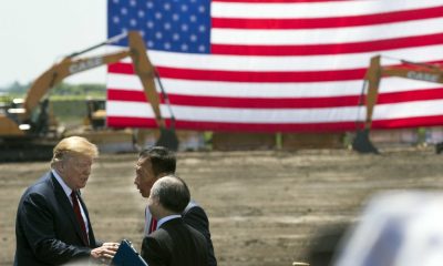 June 28, 2018; Mount Pleasant, WI, USA; President Trump (left) and Foxconn chairman Terry Gou (back) and Softbank CEO Masayoshi Son are shown during the ceremonial groundbreaking for Foxconn's factory in Mount Pleasant. The Taiwanese-Based firm has said “categorically” that it remains committed to investing the full $10 billion in what it has named the Wisconn Valley Science and Technology Park, and to creating 13,000 jobs. The factory will create display panels out of immense sheets of wafer-thin glass. Mandatory Credit: Mark Hoffman/Milwaukee Journal Sentinel via USA TODAY NETWORK