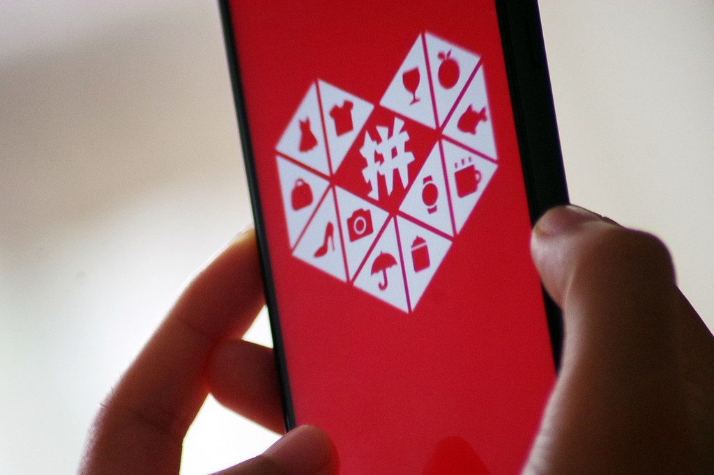 "A Chinese mobile phone user uses the mobile app of Chinese online group discounter Pinduoduo Inc. on his smartphone in Ji'nan city, east China's Shandong province, 15 August 2018."