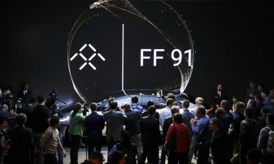 People gather around the Faraday Future's FF 91 electric car during a news conference at CES International on Tuesday, Jan. 3, 2017, in Las Vegas. (AP Photo/Jae C. Hong)