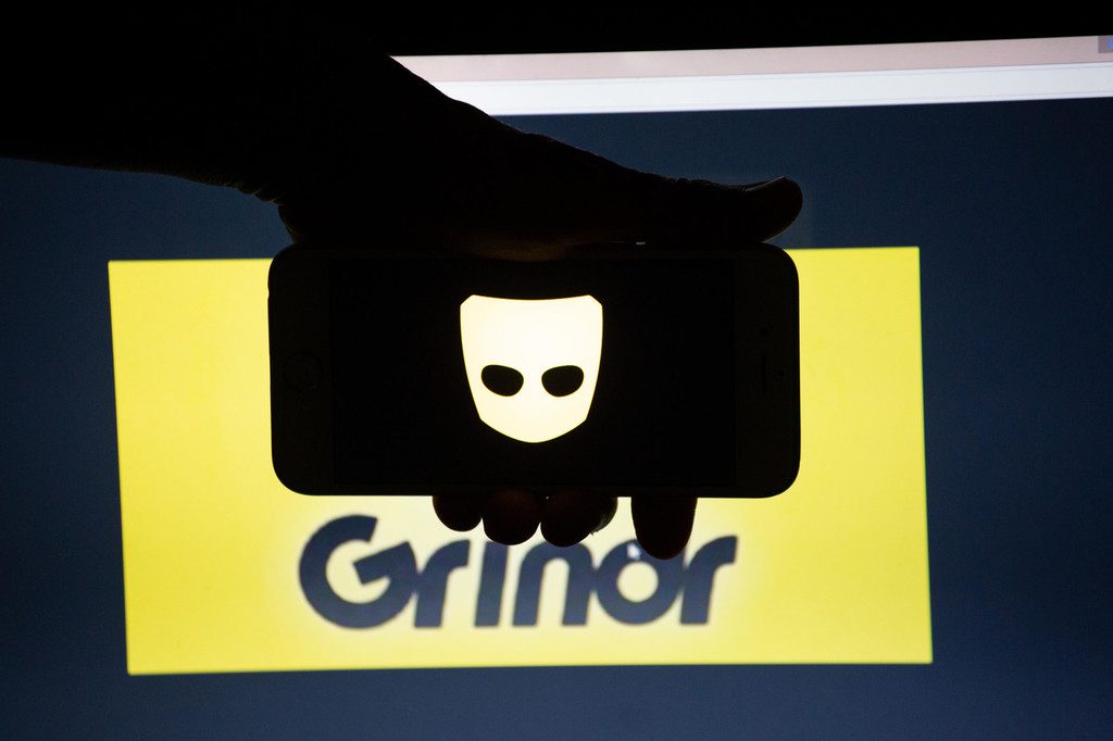 August 20, 2018 - Munich, Bavaria, Germany - The logo of the dating app Grindr is seen on a mobile screen and a laptop screen. Grindr is a dating app for gay, bi, pan and curious men. Several Millions use Dating Apps every day