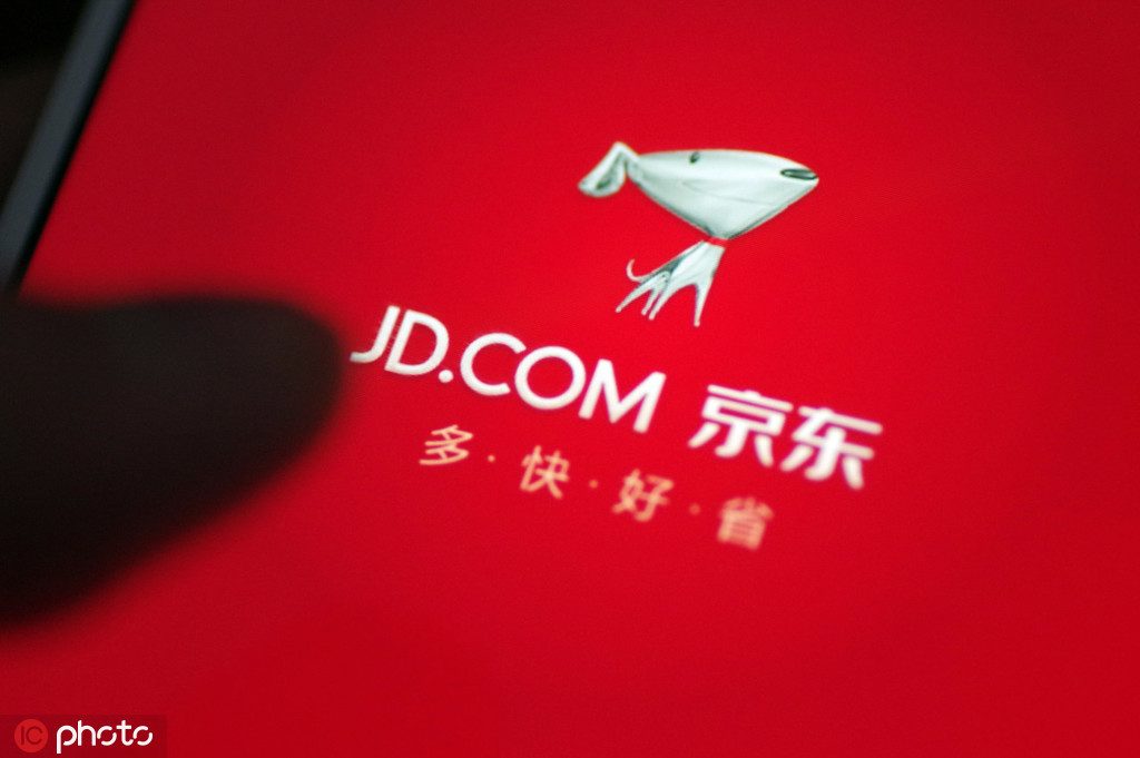"A Chinese mobile phone user uses the mobile app of online shopping site of Chinese online retailer JD.com on his smartphone for shopping in Ji'nan city, east China's Shandong province, 25 October 2017."