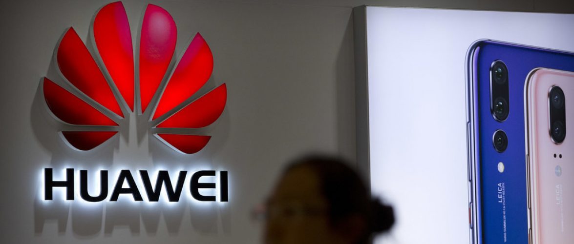 FILE - In this July 4, 2018, file photo, a shopper walks past a Huawei store at a shopping mall in Beijing. Canadian authorities said Wednesday, Dec. 5, 2018,  that they have arrested the chief financial officer of China's Huawei Technologies for possible extradition to the United States. (AP Photo/Mark Schiefelbein, File)
