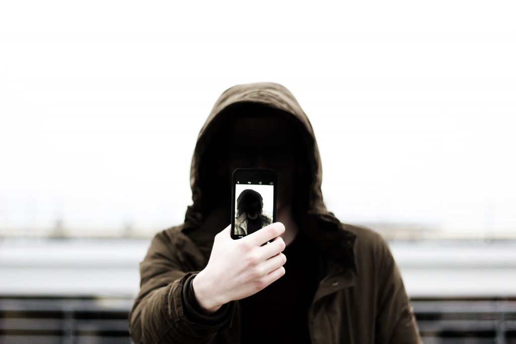 Man holding smartphone. Photo from Unsplash.