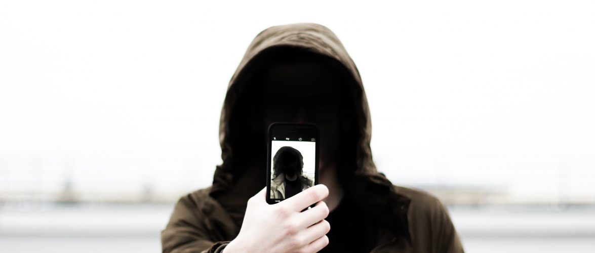 Man holding smartphone. Photo from Unsplash.