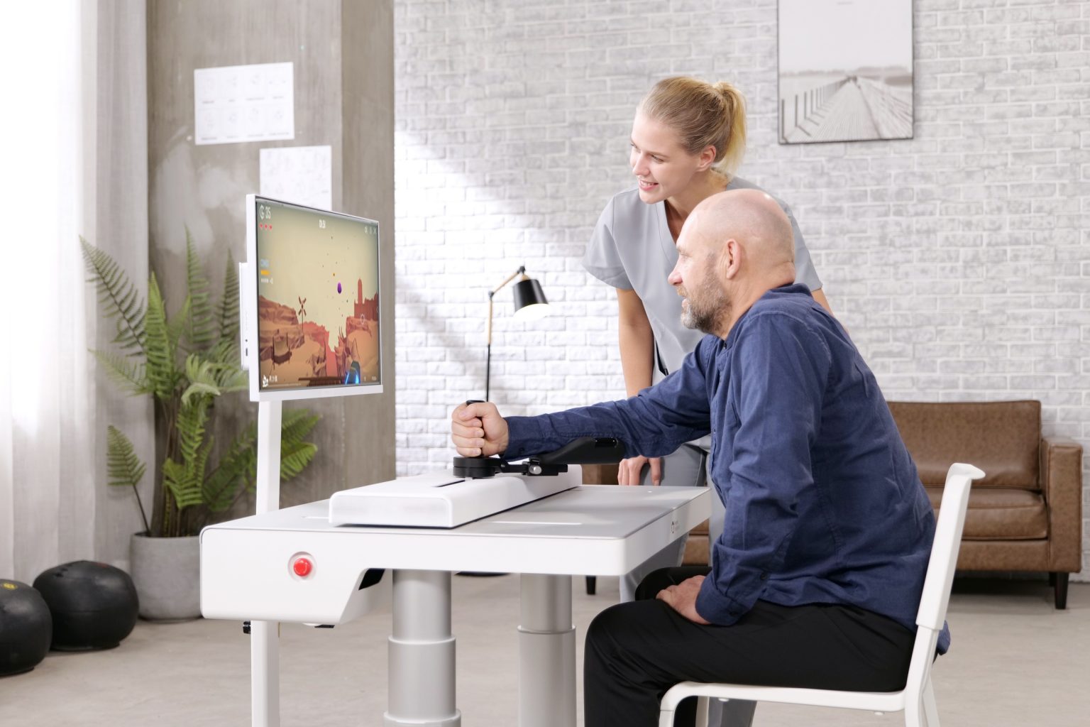 A patient is using a Fourier ArmMotus robot to help the arm recover. [Photo: KrASIA]