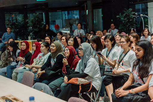 Participants of the Tech for Good hackathon listening to final pitches from different groups in 2019. 