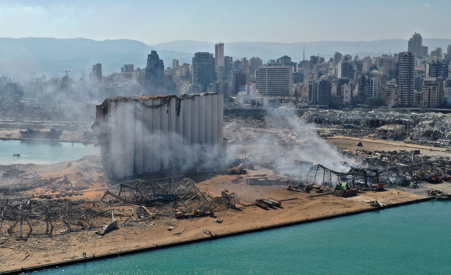 An aerial view shows the massive damage done to Beirut port's grain silos and the area around it on August 5, 2020, one day after a mega-blast tore through the harbor in the heart of the Lebanese capital. Source: Shutterstock.