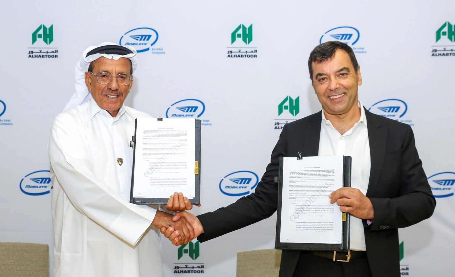 Mobileye's Amnon Shashua and Khalaf Ahmad Al Habtoor, founding chairman of Al Habtoor Group, sign a strategic partnership deal to deploy self-driving vehicles in Dubai. Courtesy of Mobileye via NoCamels.