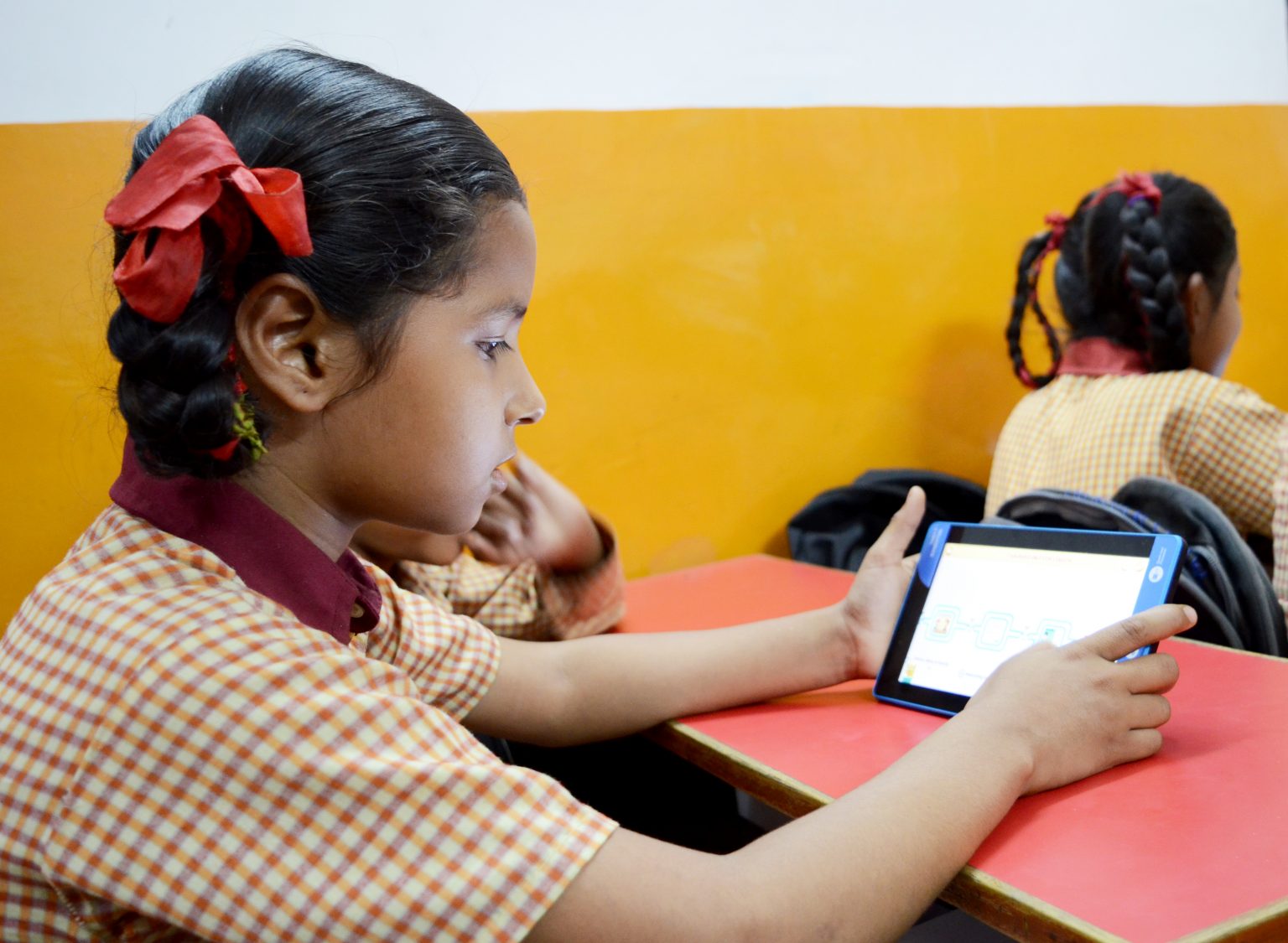A student learning through the tablet and course material provided by ConveGenius. Photo courtesy: ConveGenius