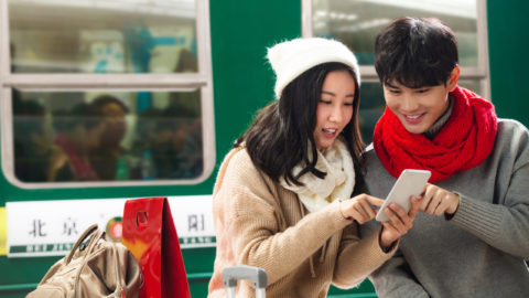 A couple is checking information via their phone. Photo: Tuchong