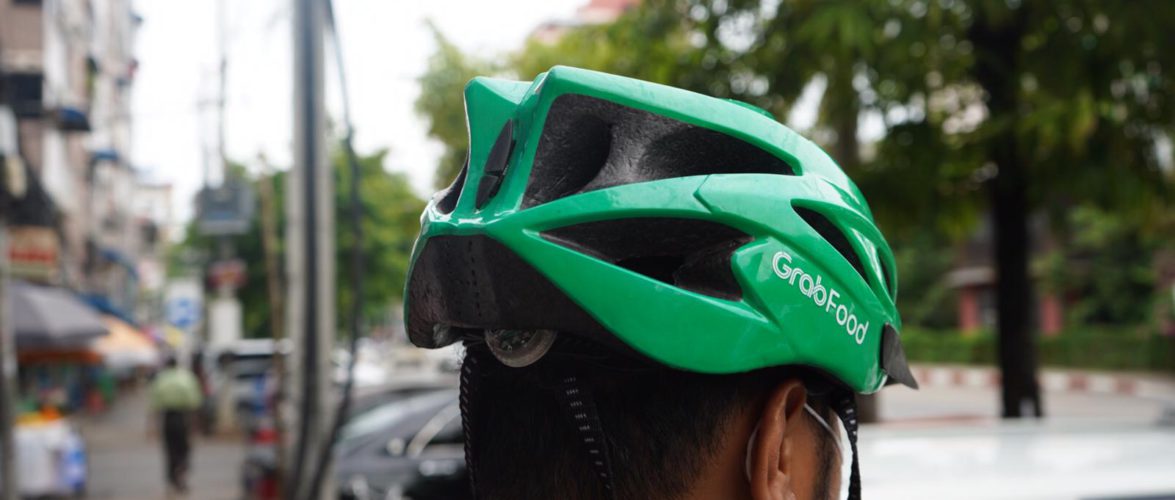 Before the coup, a full-time delivery rider could earn up to USD 90 per week in Yangon. Photo by KrASIA. 