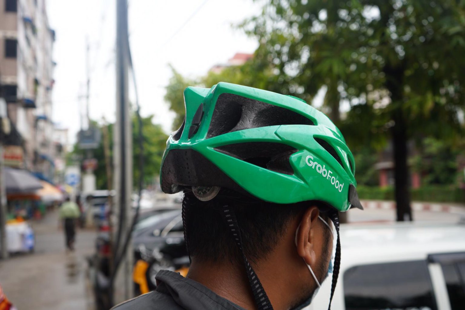 Before the coup, a full-time delivery rider could earn up to USD 90 per week in Yangon. Photo by KrASIA. 