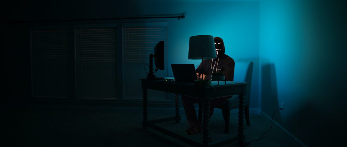 A hacker in the dark by Clint Patterson on Unsplash.