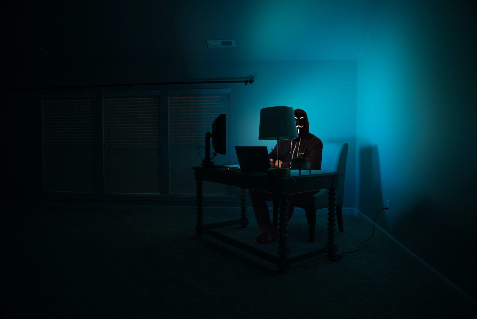 A hacker in the dark by Clint Patterson on Unsplash.