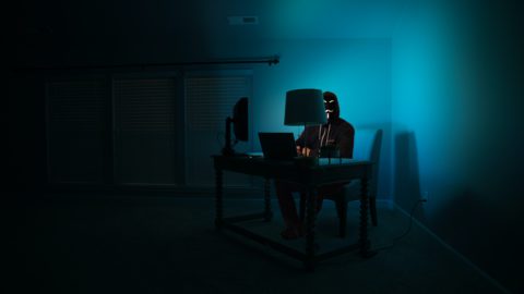 A hacker in the dark by Clint Patterson on Unsplash.