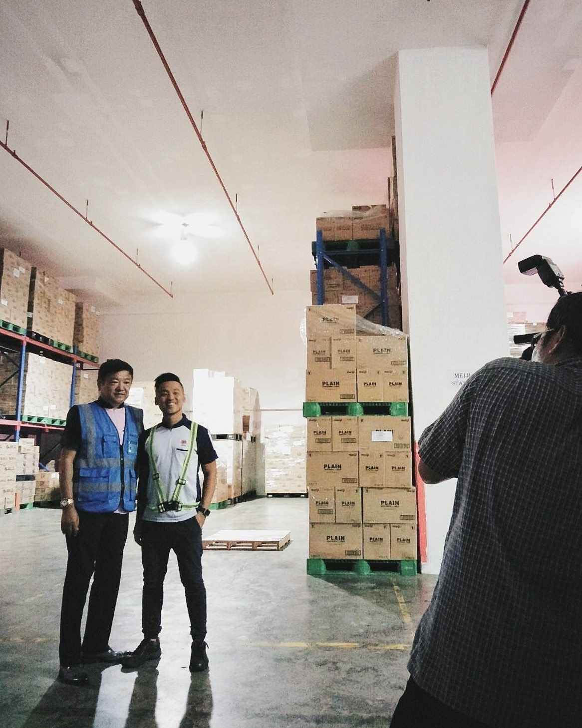 Elvin Ea (right) and his father Alex Ea in their warehouse during a photoshoot by media in 2017. Photo courtesy of Alvin Ea.