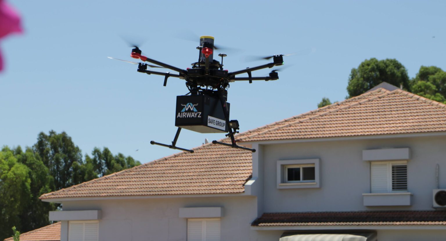 A delivery drone flies over a residential neighborhood in Hadera in June 2021. Photo by Aviv Bar-Zohar. Courtesy of Airwayz via NoCamels.