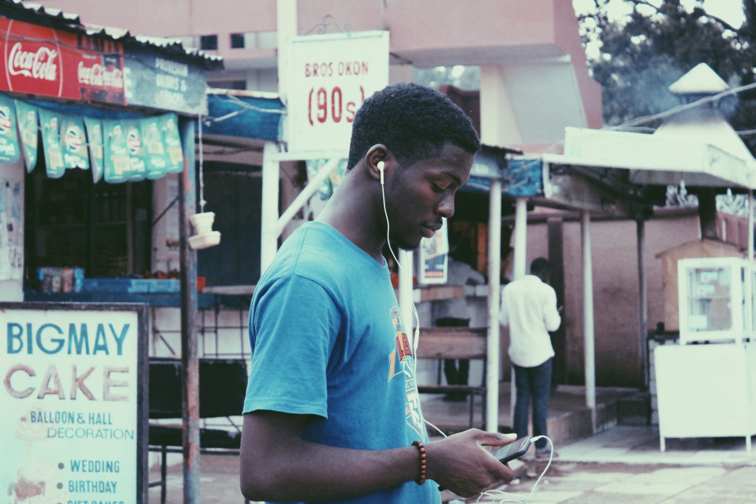 A teenager using his phone in Nigeria. Photo by Muhammadtaha Ibrahim Ma'aji on Unsplash.