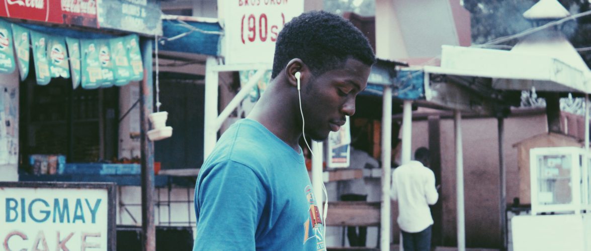 A teenager using his phone in Nigeria. Photo by Muhammadtaha Ibrahim Ma'aji on Unsplash.