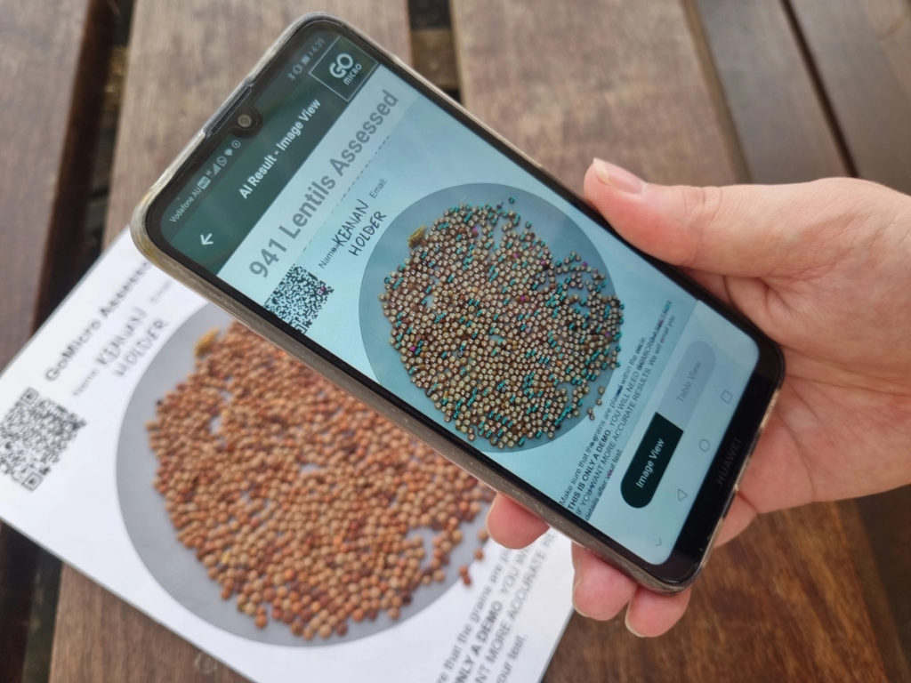 Photo of a smartphone being used to assess a pile of lentils as part of a demo.