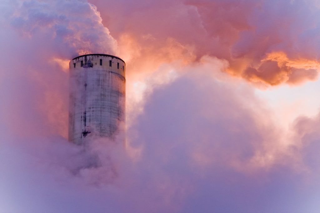 Photo of a power plant emitting smoke.