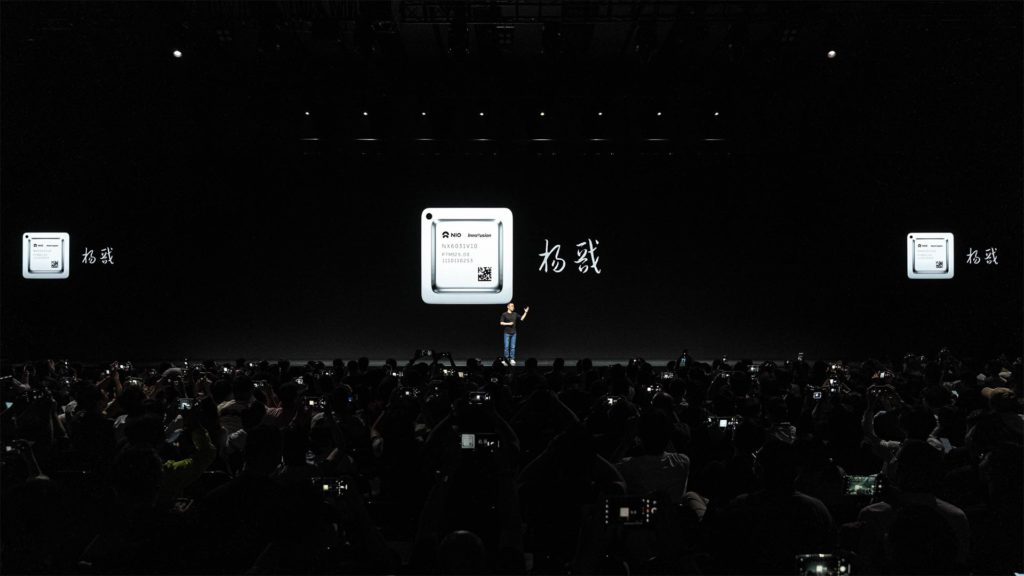 Photo of Nio CEO William Li introducing the Yang Jian chip during the Nio IN 2023 event.