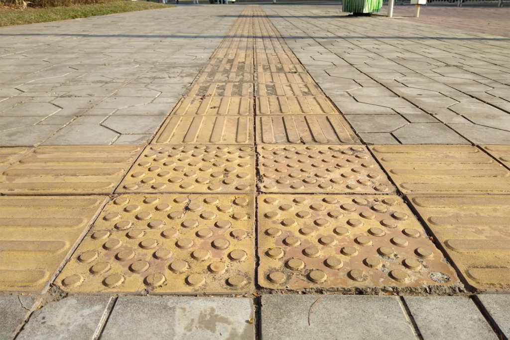 Photo of a tactile pavement on a sidewalk in a suburban area of Shenzhen, China.
