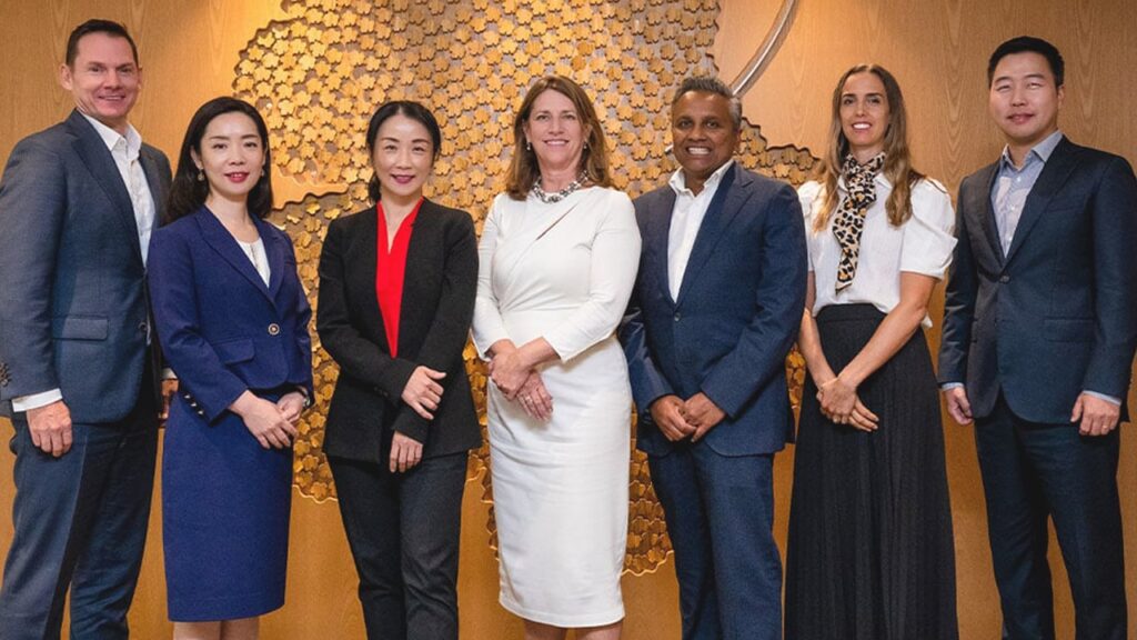 Photo of team members from the Queensland Investment Corporation (QIC) at the organization’s Singapore office. From left to right: Ryan Gordon, Ayako Mitsui, Vicky Wei, Kylie Rampa, Ravi Sriskandarajah, Shiree Hocking, and Ryan Choi.