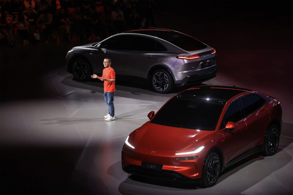 Photo of Alan Ai revealing the Onvo L60 electric vehicle at its unveiling event in May 2024.