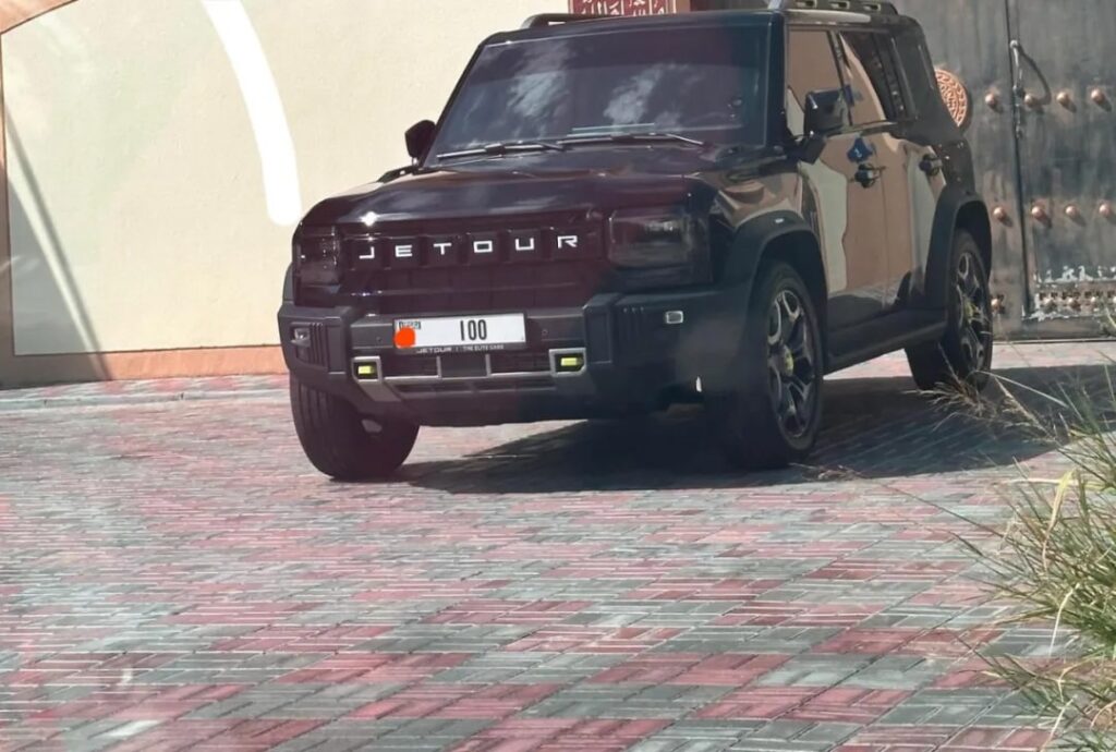 Photo shows a black Jetour T2 with the license plate number 100 in Dubai. License plates with two or three digits can cost up to AED 1 million.