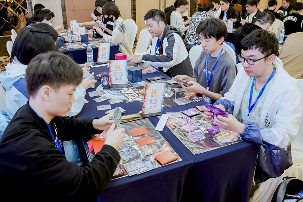 Photo captures trading card game players in competition.