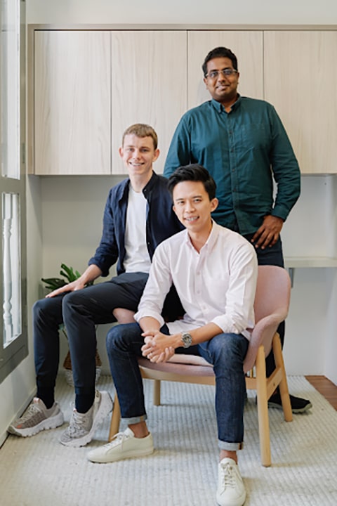 Photo of Arrow Checkout’s core team: Sebastian Roervig, COO, seated on the armrest; Neo Liat Beng, CEO, seated on the chair; and Sudhan Raj, CTO, standing behind them.