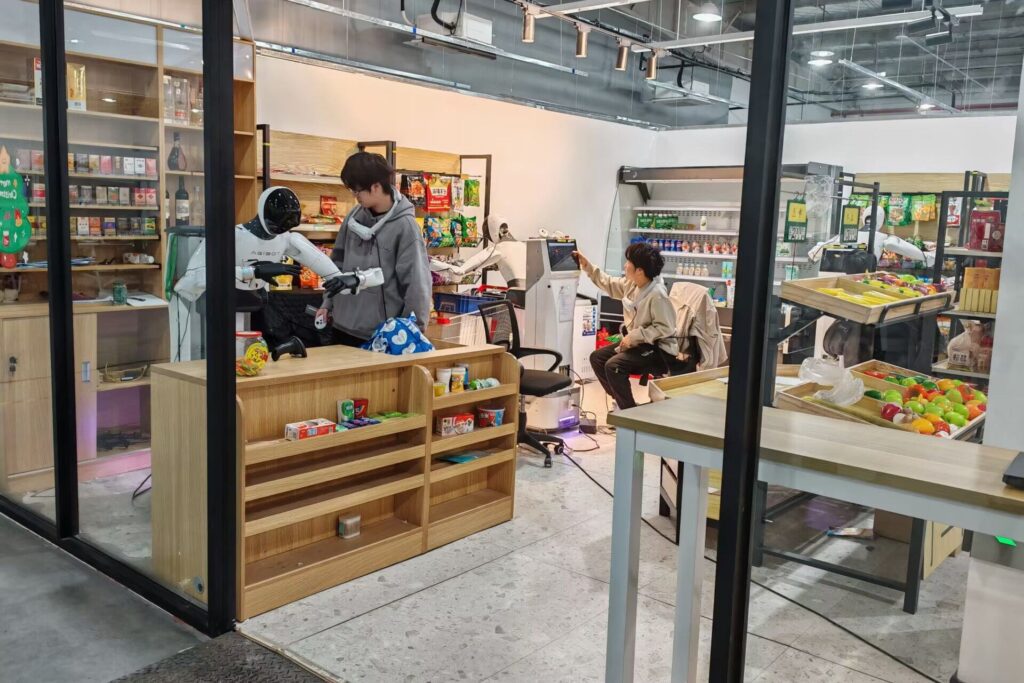 Photo of what seemed, at first glance, to be an actual supermarket. Inside, Agibot staff members were seen working alongside humanoid robots, guiding them through simulations of common tasks performed in supermarkets, such as scanning product QR codes and stocking shelves.