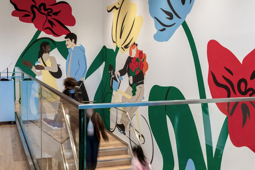 Photo features a mural illustrated by Sandy van Helden at Uniqlo’s Koningsplein store.