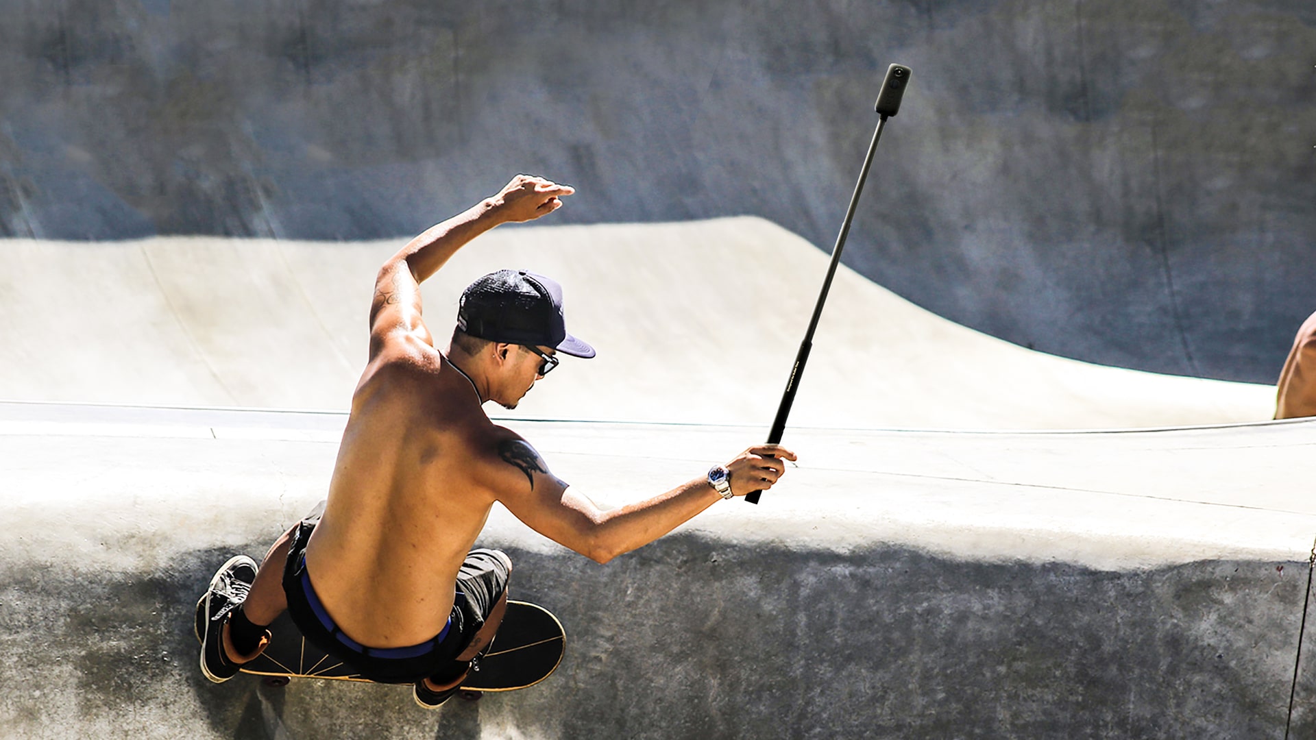 Photo of a skateboarder using a selfie stick-mounted One X.