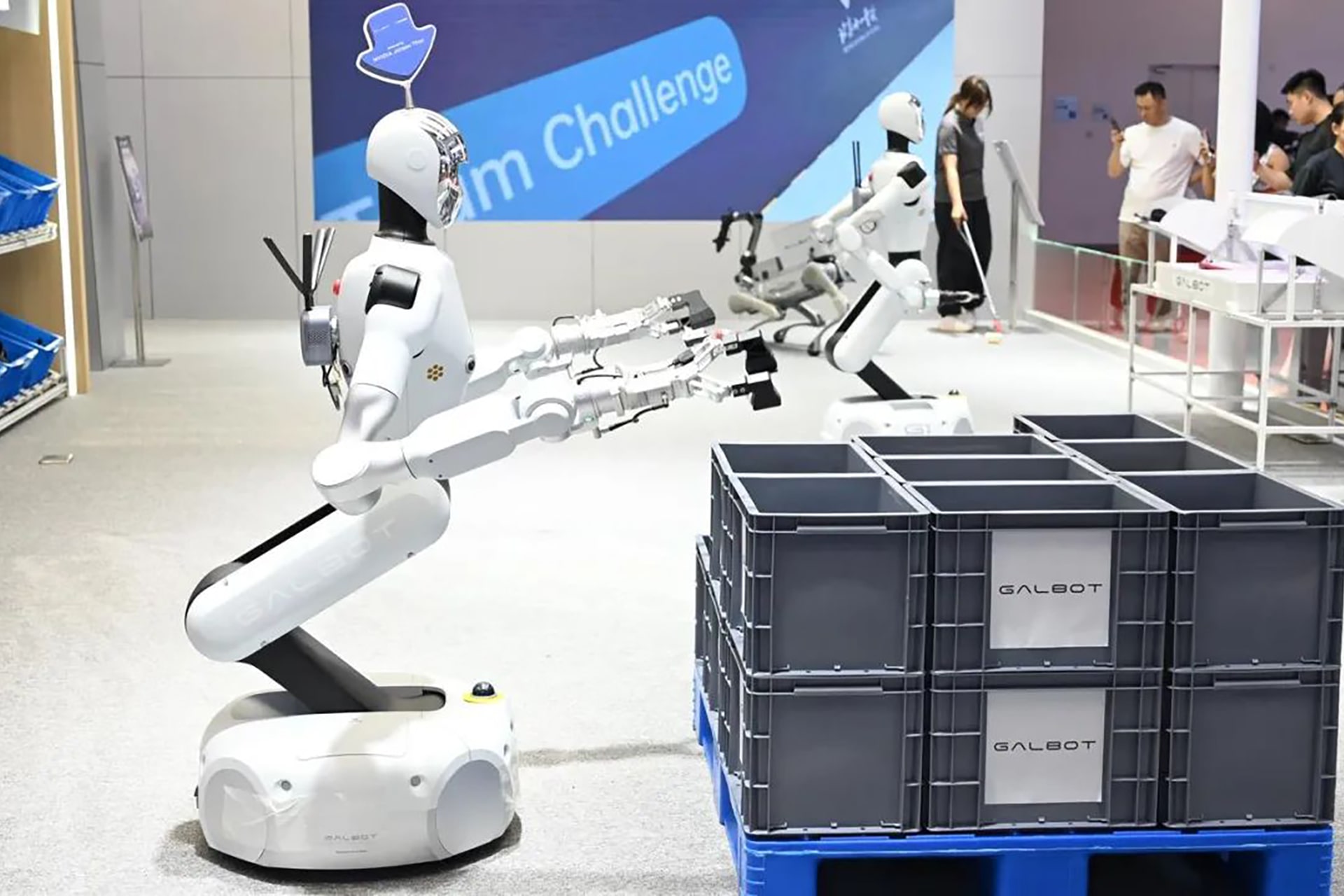 Photo shows a Galbot demo of an industrial bin handling scenario.