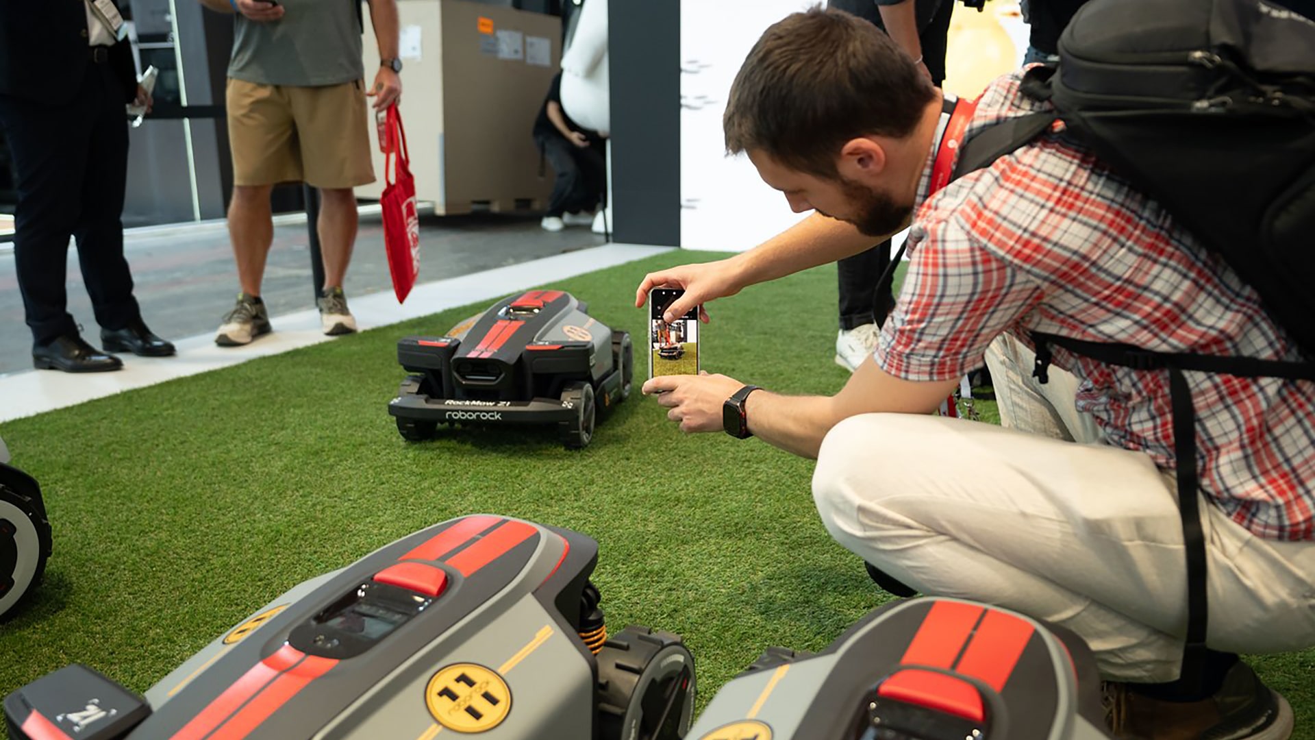 Photo of visitors checking out Roborock’s RockMow Z1 mower.