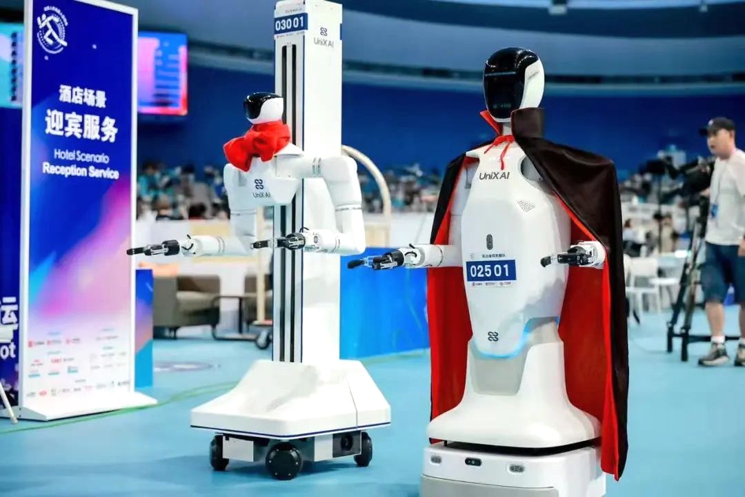 Photo of Unix AI’s second-generation robot (right) beside its latest third-generation model.