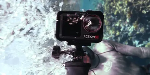 DJI’s Action 5 Pro, shown with its underwater filming capabilities.