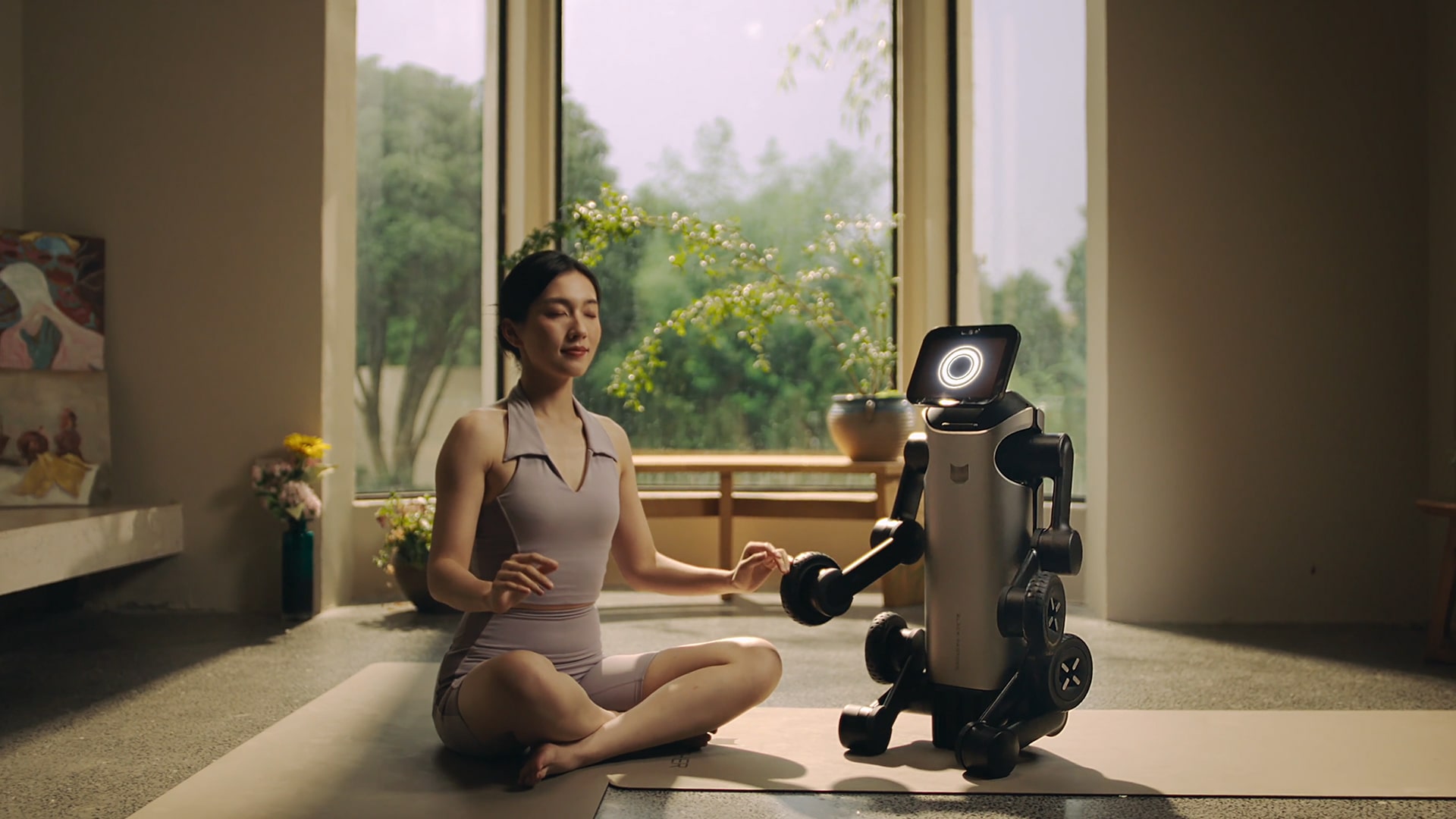 Image showing the Baobao robot serving as a yoga companion for a female user.