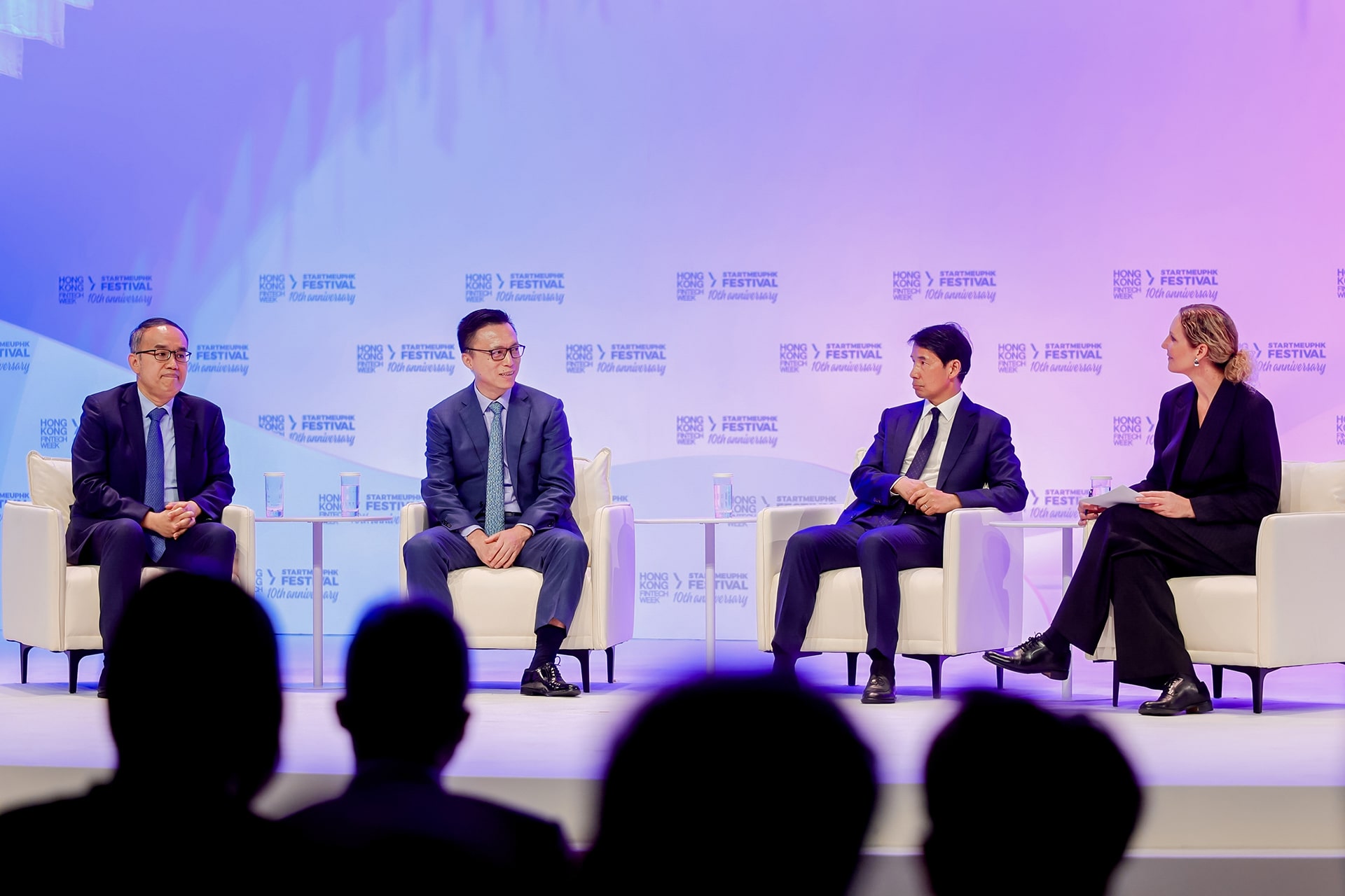 Photo of Ant Group chairman Eric Jing (second from left) speaking during a panel discussion at Hong Kong Fintech Week 2025, alongside Christopher Hui (first from left), Hong Kong’s secretary for financial services and the treasury; Fred Hu (second from right), founder, chairman, and CEO of Primavera Capital Group; and moderator Drew Propson, head of technology and innovation in financial services at the World Economic Forum.