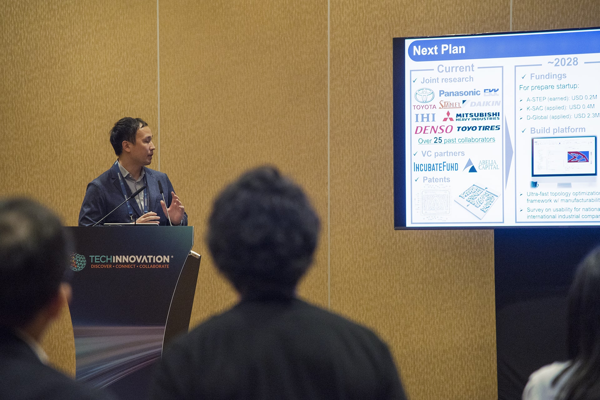 Photo of Kentaro Yaji from the University of Osaka, speaking during the event about his research on thermal-fluid topology optimization, which aims to address current heat management challenges.