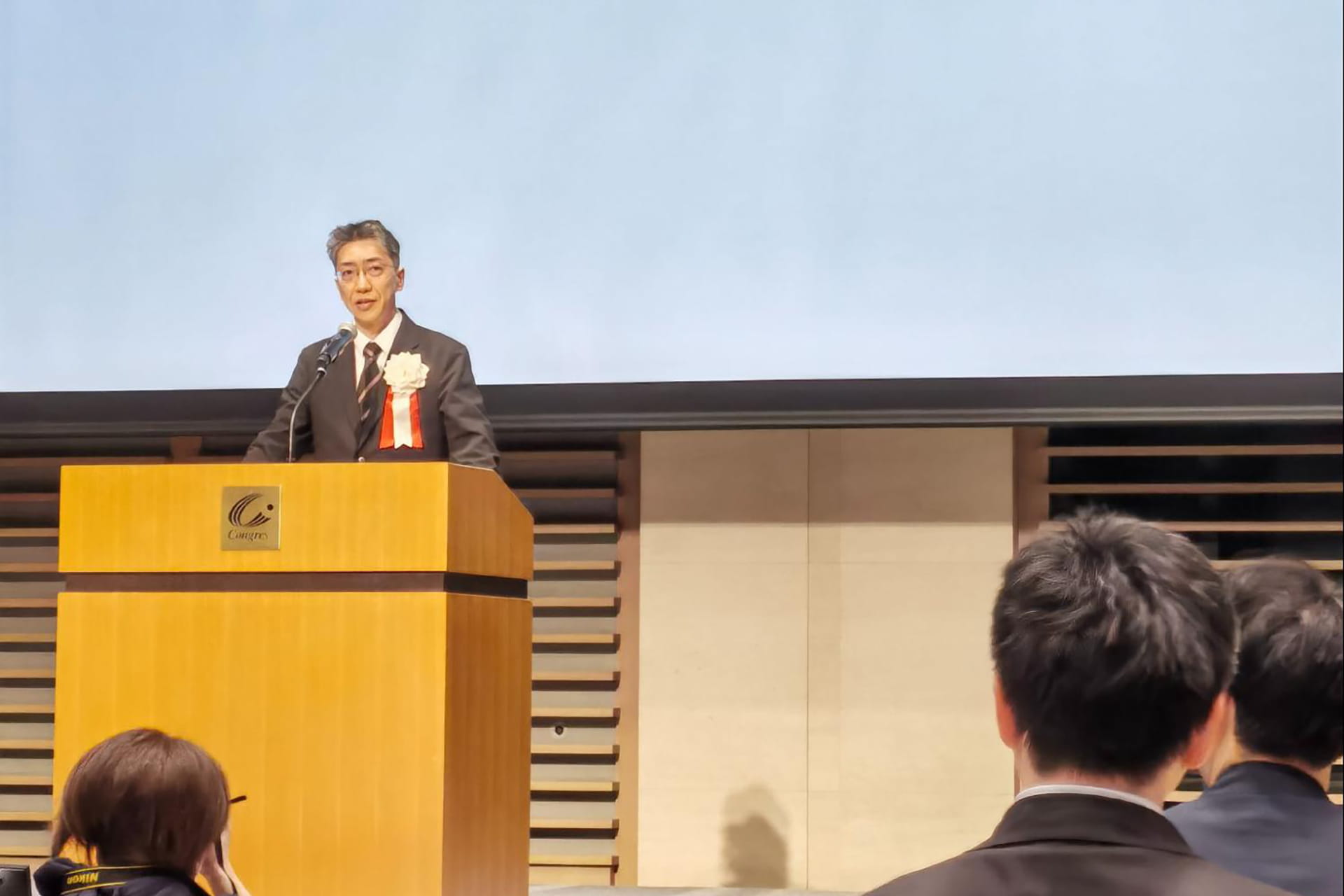 Photo of Ieaki Takeda, director general of the Kansai Bureau of Economy, Trade and Industry, speaking during the March 11 event.