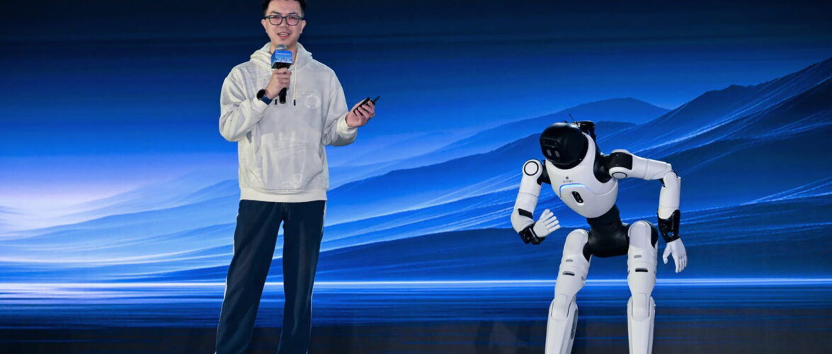Peng Zhihui, president and CTO of Agibot, on stage with one of the company’s humanoid robots. Photo source: Agibot.