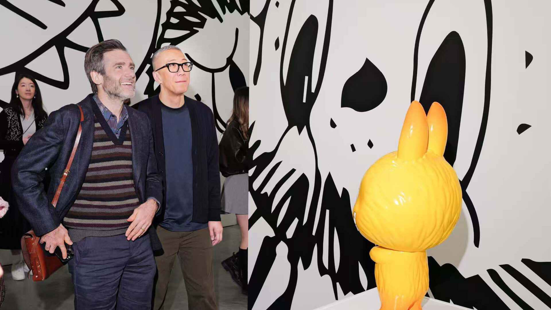 Photo shows Paul King, director of Paddington, and Lung Kasing, creator of The Monsters, pictured at the tenth anniversary exhibition of The Monsters in Paris.